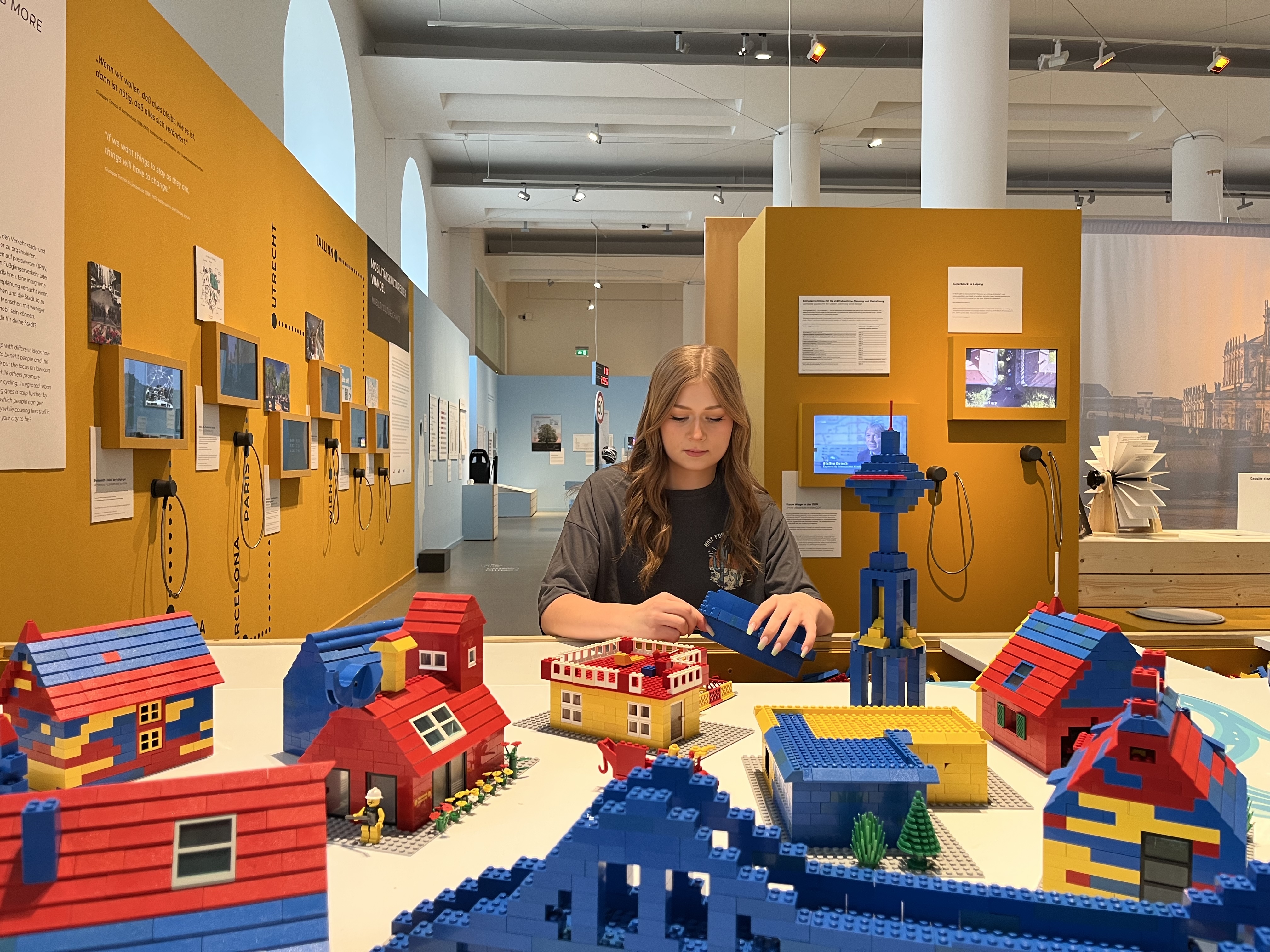 Eine Jugendliche baut Gebäude am Legotisch in der Sonderausstellung MOVE